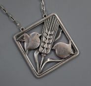 A Georg Jensen sterling 'wheatsheaf flanked by robins' square pendant, no. 93, on a fine link chain,