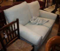 A modern pale cream upholstered two seater settee W.145cm approx.