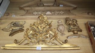 A 19th century carved giltwood door pediment, another giltwood carving of a lion rampant and an