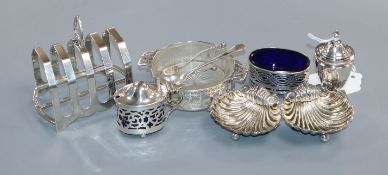 A pair of silver shell salts, a pepper pot and silver salt with glass liner and a matching pair of