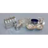 A pair of silver shell salts, a pepper pot and silver salt with glass liner and a matching pair of