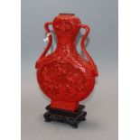 A cinnabar lacquer vase on associated hardwood stand height 20.5cm excluding stand
