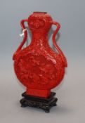 A cinnabar lacquer vase on associated hardwood stand height 20.5cm excluding stand