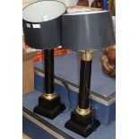 A pair of gilt metal mounted ebonised table lamps on square plinth base