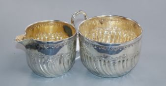 A late Victorian silver wrythen fluted cream jug and sugar bowl, Sheffield, 1890, 112 grams.