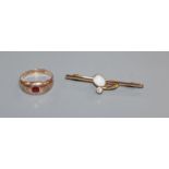 An early 20th century 15ct, white opal and diamond bar brooch and a 9ct gold gypsy set ruby and