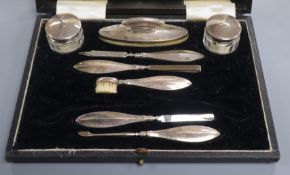 A cased 1930's eight piece (ex ten) silver mounted manicure set.