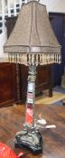 A gilt and silvered metal table lamp with mirrored triangular column