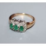 A 9ct gold, three stone emerald and diamond cluster ring, size O.