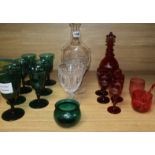 A set of six dark green wine glasses, a vine etched ruby glass decanter and five matching liqueur