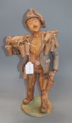 A signed terracotta figure, 'The strawberry seller', indistinctly signed height 43cm