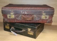 A green leather travel case and a suitcase