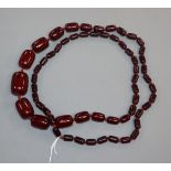 A single strand graduated simulated dark cherry amber necklace, gross weight, 98 grams, 100cm.
