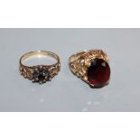 A 9ct and oval garnet set ring and one other 9ct gem set ring.