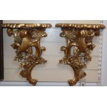 A pair of Rococo-style carved giltwood wall brackets