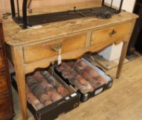 An early 19th century pine two drawer side table W.120cm