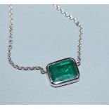 An 18ct white gold and solitaire emerald set pendant necklace, pendant 9mm.