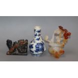 A small Chinese blue and white vase, a chalcedony basket of flowers and a dragon figure