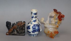 A small Chinese blue and white vase, a chalcedony basket of flowers and a dragon figure