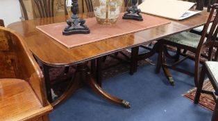 A George III style mahogany twin pillar dining table 208cm extended (one spare leaf)