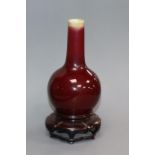 A small Chinese Langyao sang de boeuf bottle vase, 18th century, restored rim, wood stand Provenance