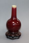 A small Chinese Langyao sang de boeuf bottle vase, 18th century, restored rim, wood stand Provenance