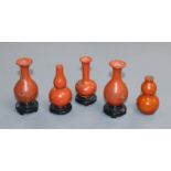 A group of four Chinese lacquer wood miniature vases and a similar pottery double gourd vase (5)