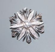 A modern textured 585 white metal and diamond set flowerhead brooch, 36mm.