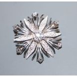 A modern textured 585 white metal and diamond set flowerhead brooch, 36mm.