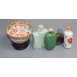 Four 19th century Chinese snuff bottles and a Canton famille rose bowl, wood stand