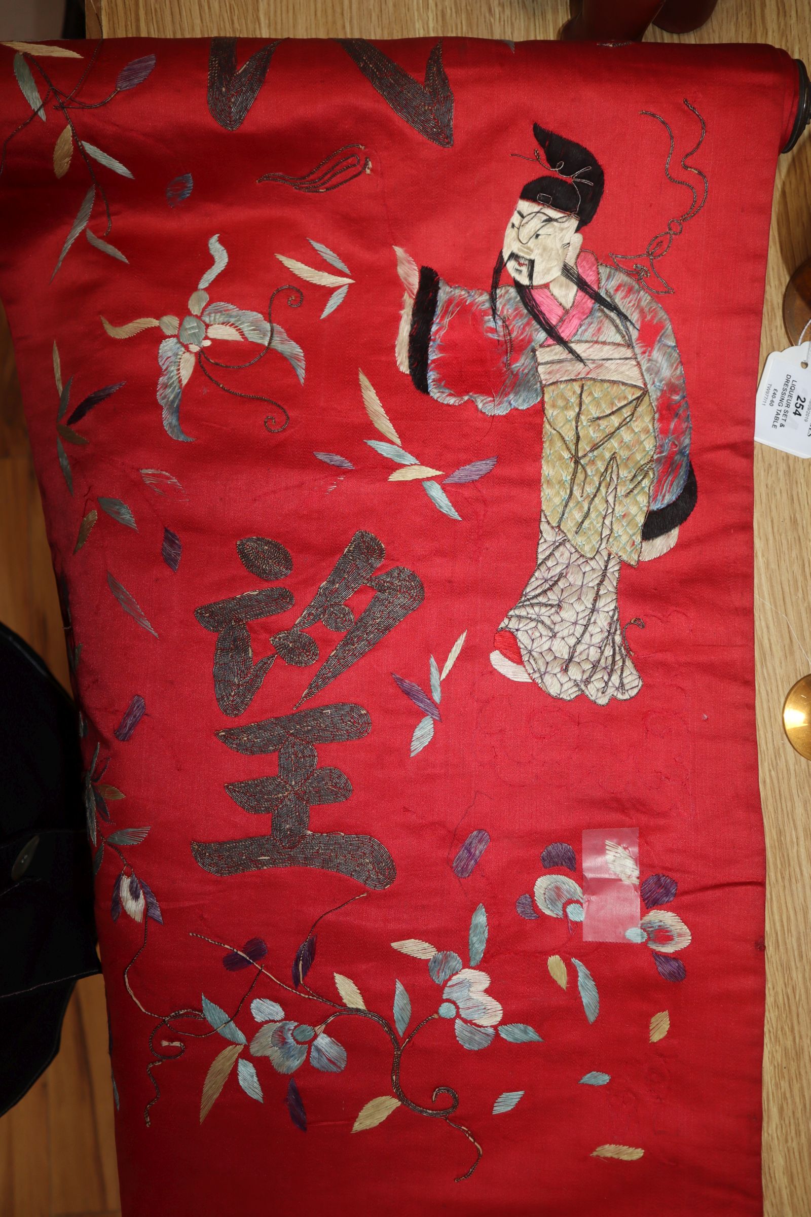 A Chinese red silk banner embroidered with figures, flowers, insects and calligraphy, on brass- - Image 2 of 7