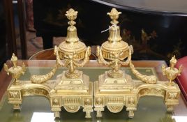 A pair of French gilt metal chenet