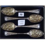 A set of four plated berry spoons