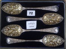 A set of four plated berry spoons