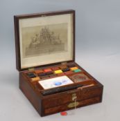 A 19th century bird's eye yew artist's paint box by R.Ackermann containing Newmans paint blocks