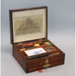 A 19th century bird's eye yew artist's paint box by R.Ackermann containing Newmans paint blocks