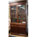 A pair of George III and later mahogany bookcases, each having glazed upper part over a pair of