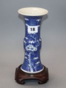 A Chinese blue and white 'prunus' beaker vase, 19th century, wood stand height 20cm excluding