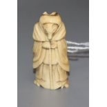 An 18th/19th century staghorn netsuke of a fox dressed as a woman