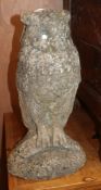 A pair of reconstituted stone owl garden ornaments, height 44cm