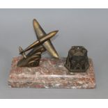A novelty patinated spelter 'aeroplane' inkstand
