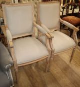 A pair of French painted beech fauteuils