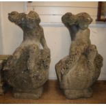 A pair of reconstituted stone Bacchanalian cherubs sitting on wine barrels H.94cm