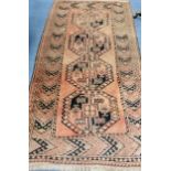 A Caucasian red ground rug 215 x 118cm