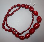 A single strand graduated simulated cherry amber necklace, gross weight 95 grams, 86cm.