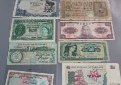 A collection of banknotes, coins and tokens.