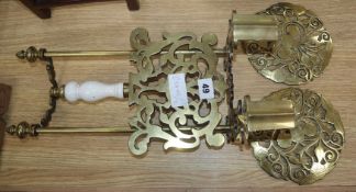 An ornate brass fire trivet and decorations from andirons