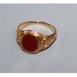 An early 20th century 18ct gold and carnelian set signet ring, size O.