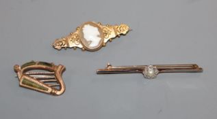A 15ct gold-mounted cameo brooch, a 9ct gold harp brooch and a pearl and diamond-set bar brooch.
