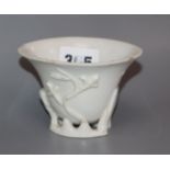 An 18th century Chinese blanc de chine 'prunus' libation cup